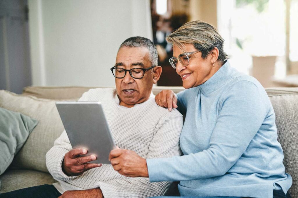 A man and woman looking at a tablet
