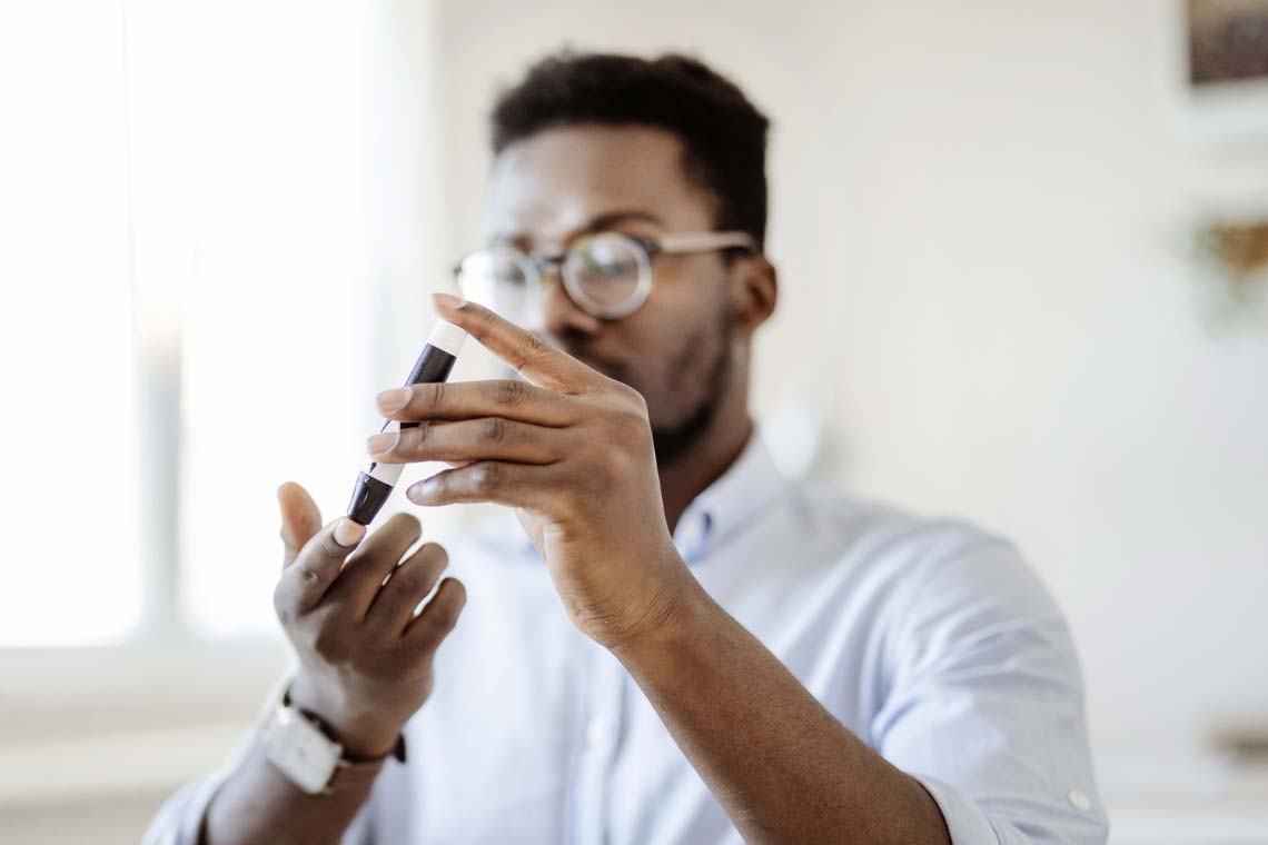 Man testing blood sugar